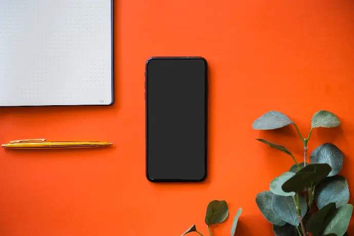 black iphone 5 on orange surface